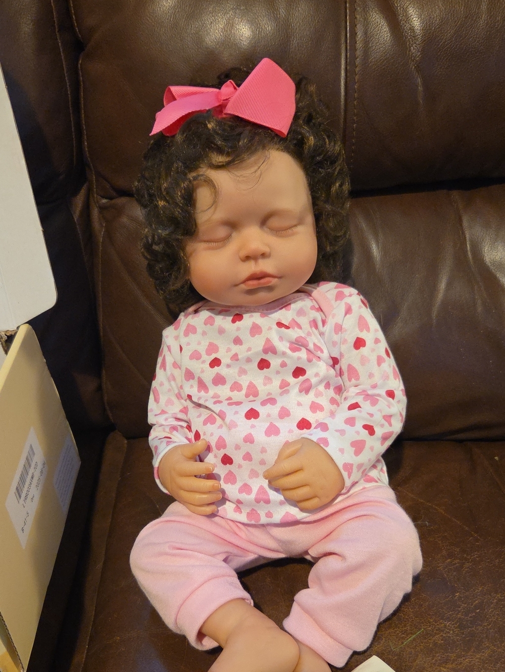 Reborn Pink Heart Sleepy Baby Doll with Dark Curly Hair and Hair Bow